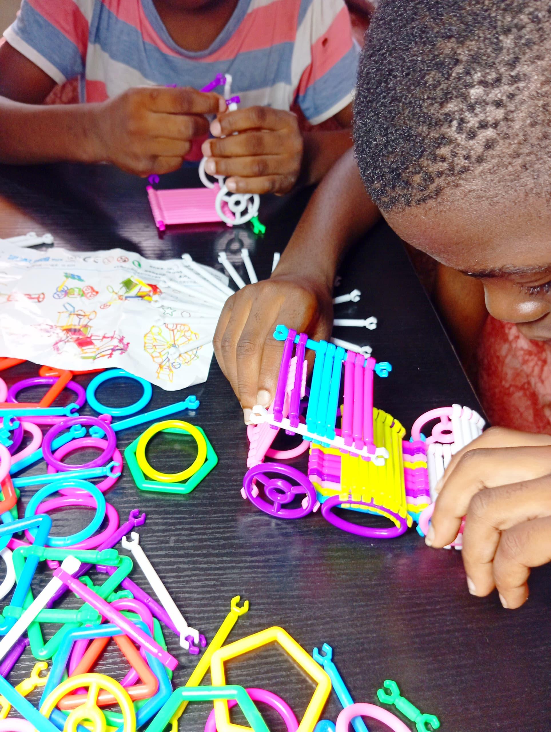 Two young learners working together on a building activity